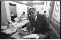 African American lawyer Vernon E. Jordan working on a voter education project, seated at a desk with a typewriter at the Southern Regional Council, Atlanta, Georgia